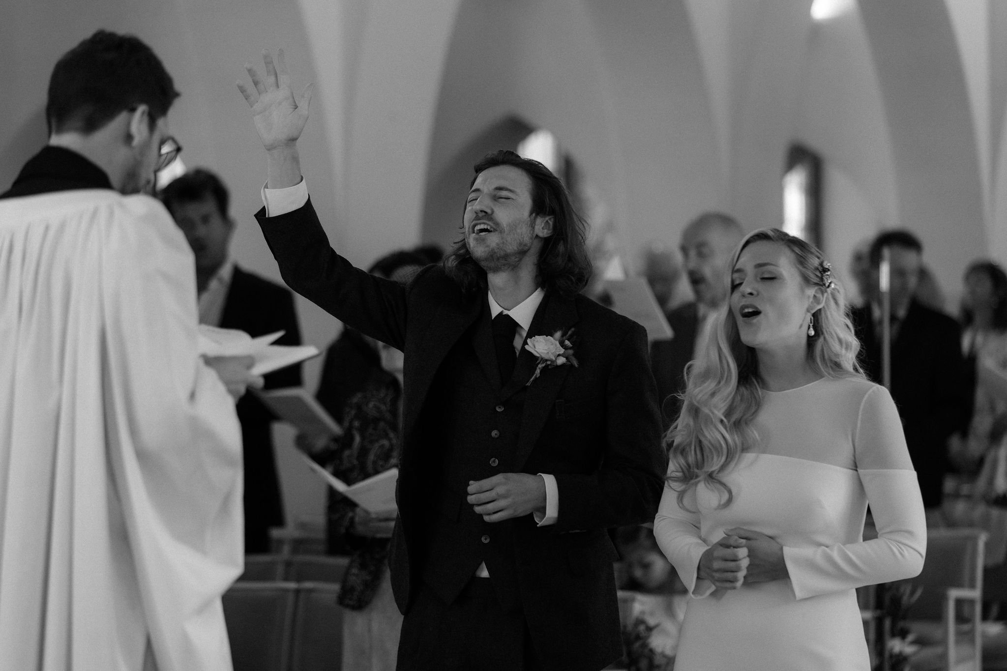 Bride and groom singing and praising god at alter