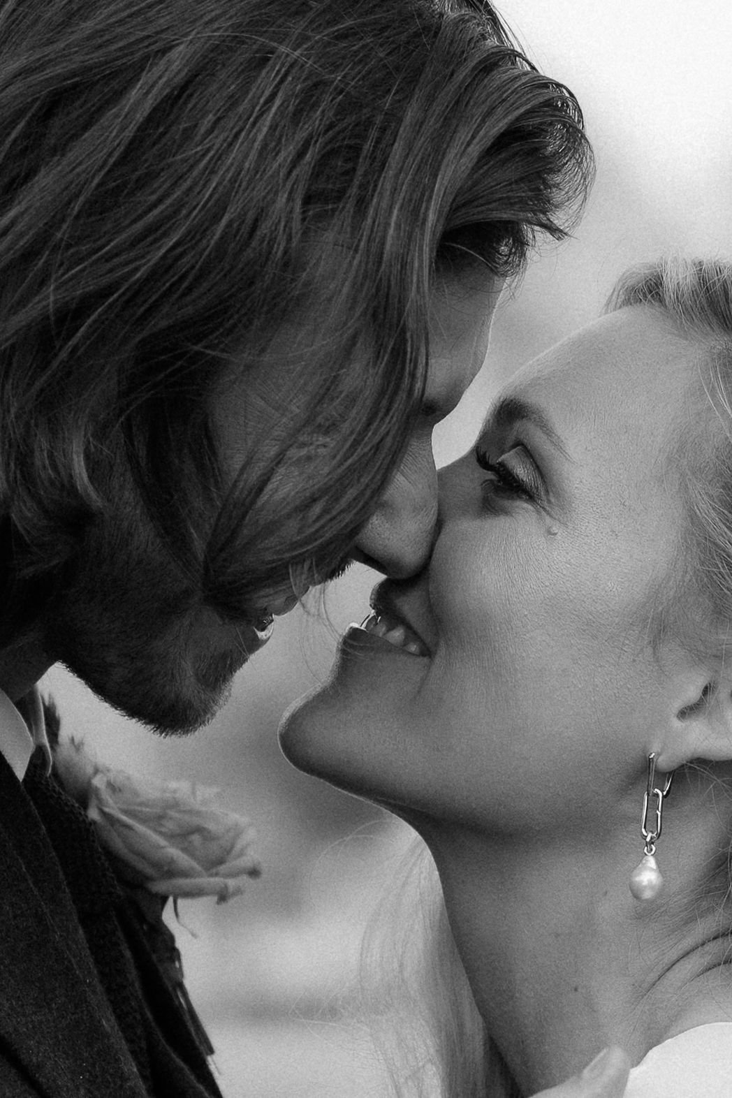 Intimate wedding photographs of close up faces smiling. Bride and groom up close smiling in black and white couple portrait