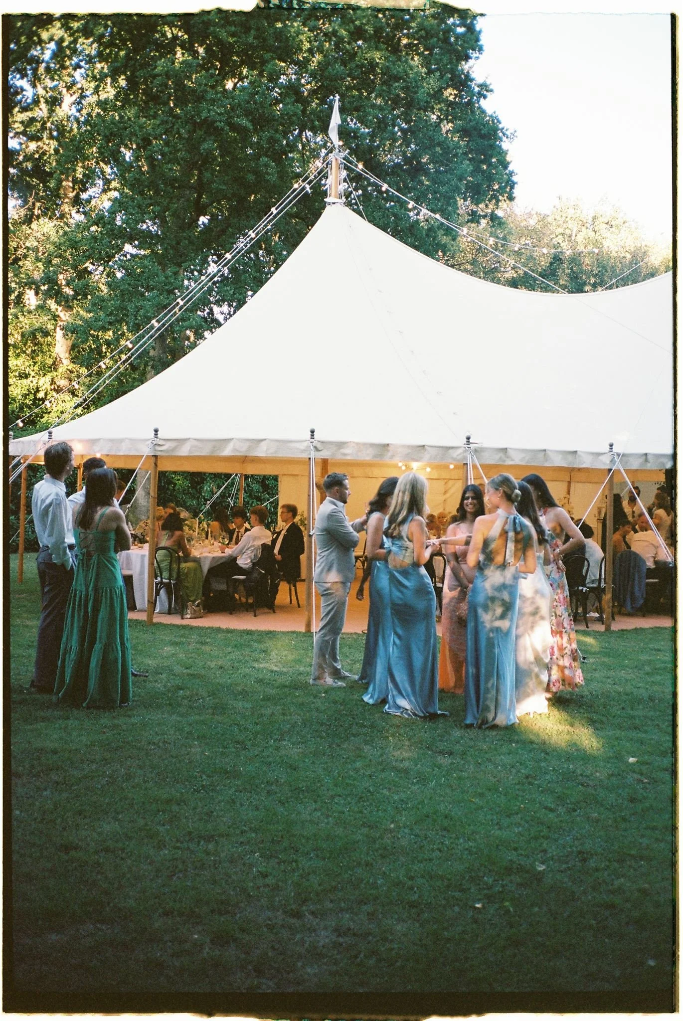 Film photo of guests outside wedding marquee