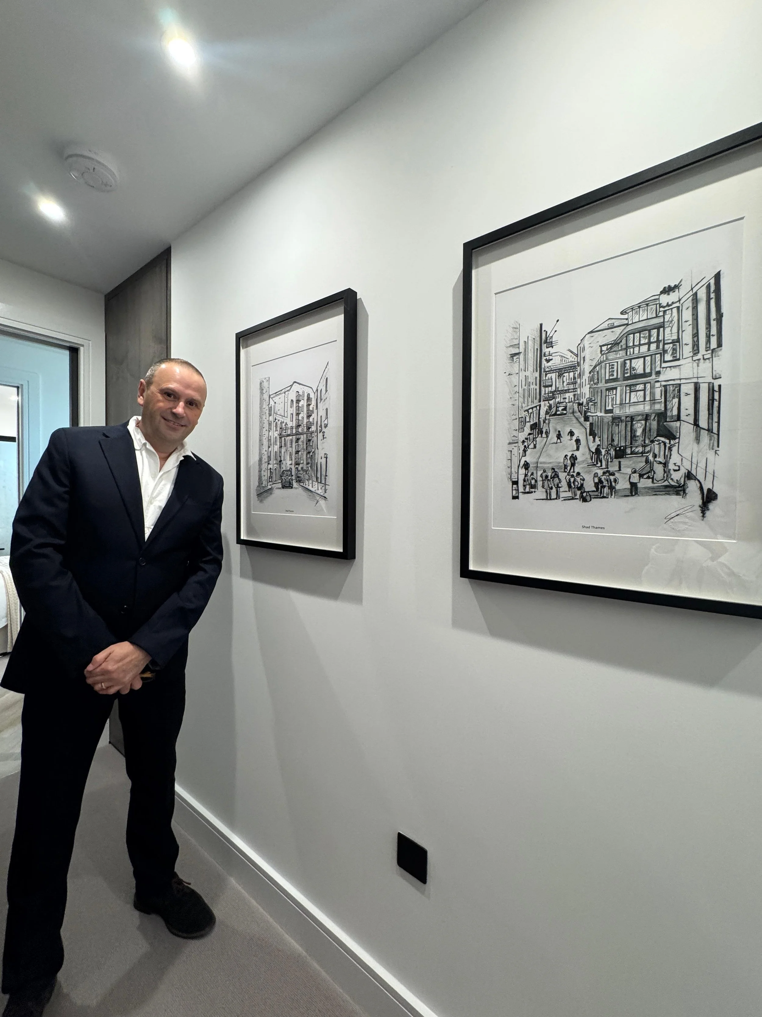Artist Magnus Rodwell showcasing artwork in a showroom apartment.