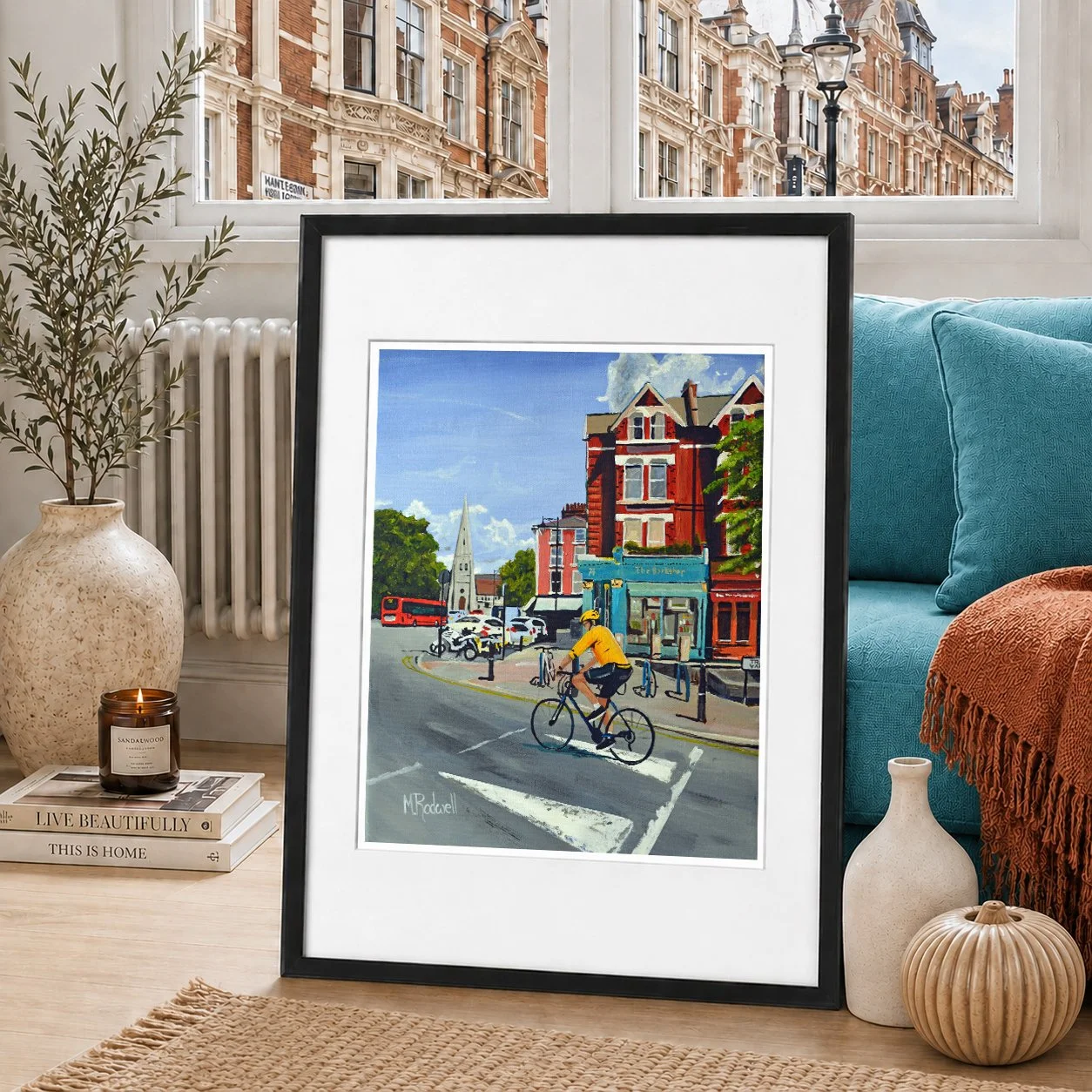 Colour illustration of man cycling up Tranquil Vale on a summers day passing the bookshop and All Saints Church