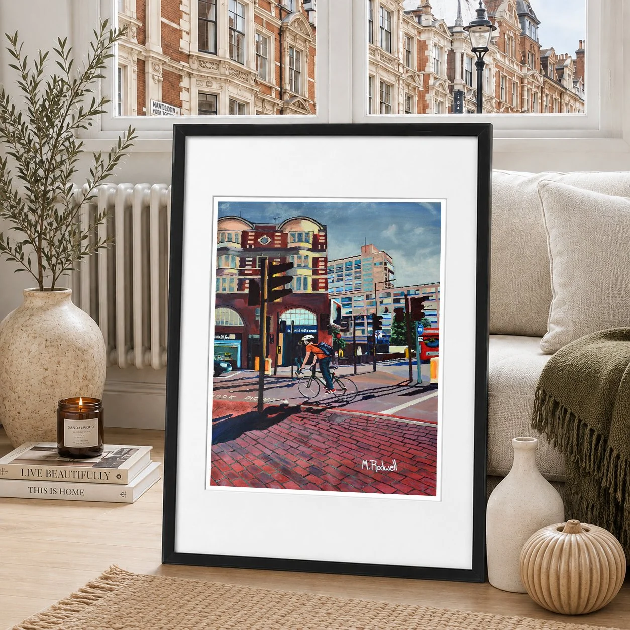 Elephant and Castle Print,  man cycling past station painted by magnus rodwell