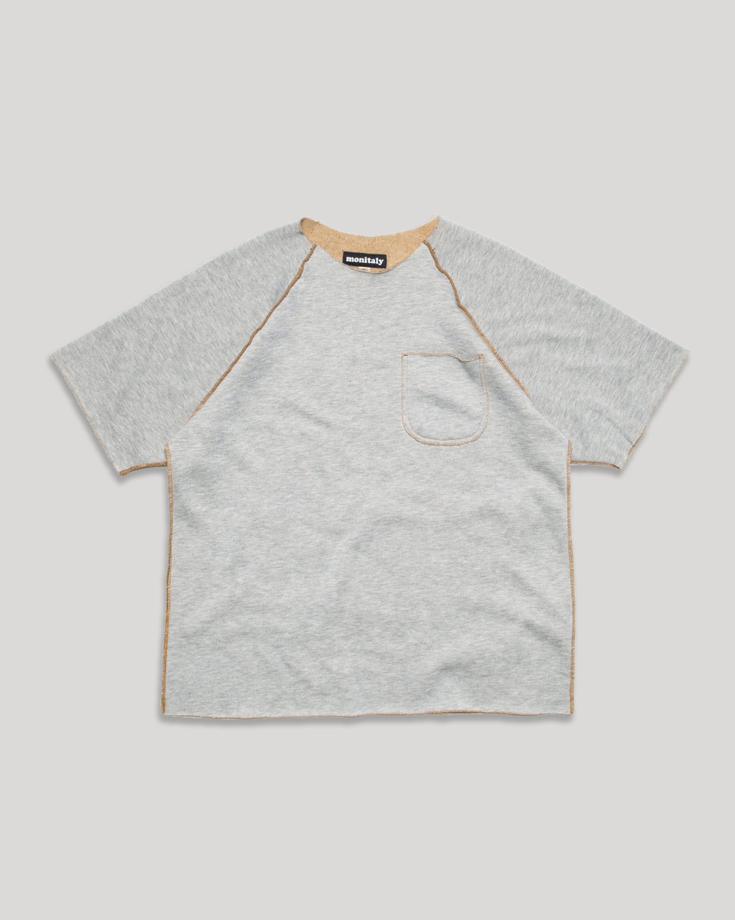 raglan sleeves for enhanced mobility and a relaxed fit. The chest pocket adds a touch of utility, while the cut-off edges lend a rugged, worn-in look. Raglan Crew Short-Sleeve.