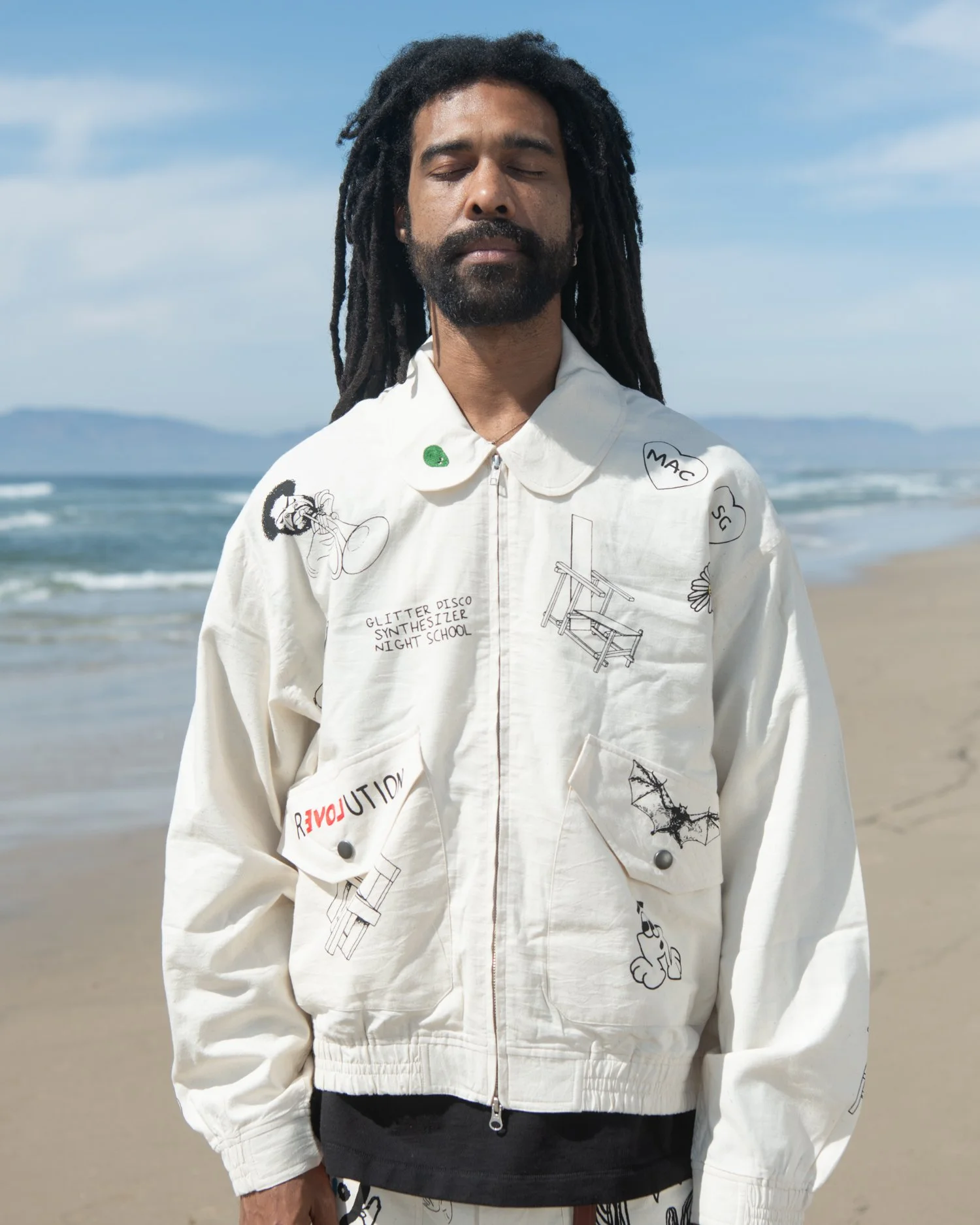 KARDO x JACOB WILDER x MONITALY collaboration hand woven Flight jacket worn by man standing on beach