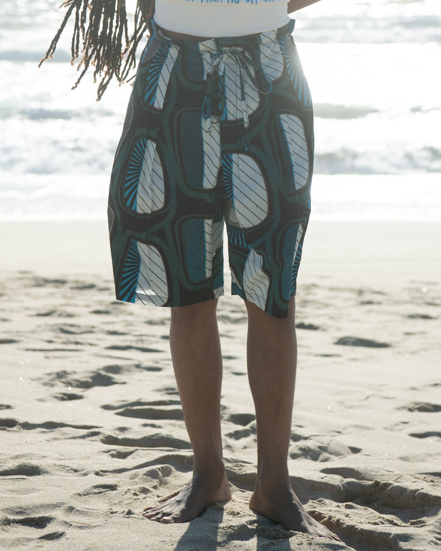 Shorts with Double pleats at the front, along with the drop crotch, create a striking silhouette. 100% cotton Original African print fabric.