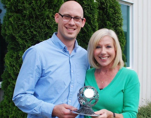 Washington County's Justin Gast and Hillsboro School District's Carol Stroup worked with students, custodians and other school staff to make Hillsboro School District's recycling program a success. They're holding the Oregon Recycler of the Year Award given by the Association of Oregon Recyclers (Courtesy of Hillsboro School District).