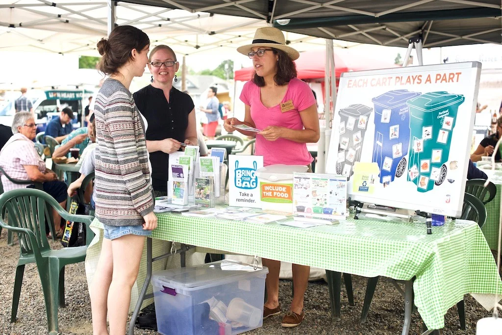Meredith and classmate Carmen chat about recycling at Montavilla Farmers' Market