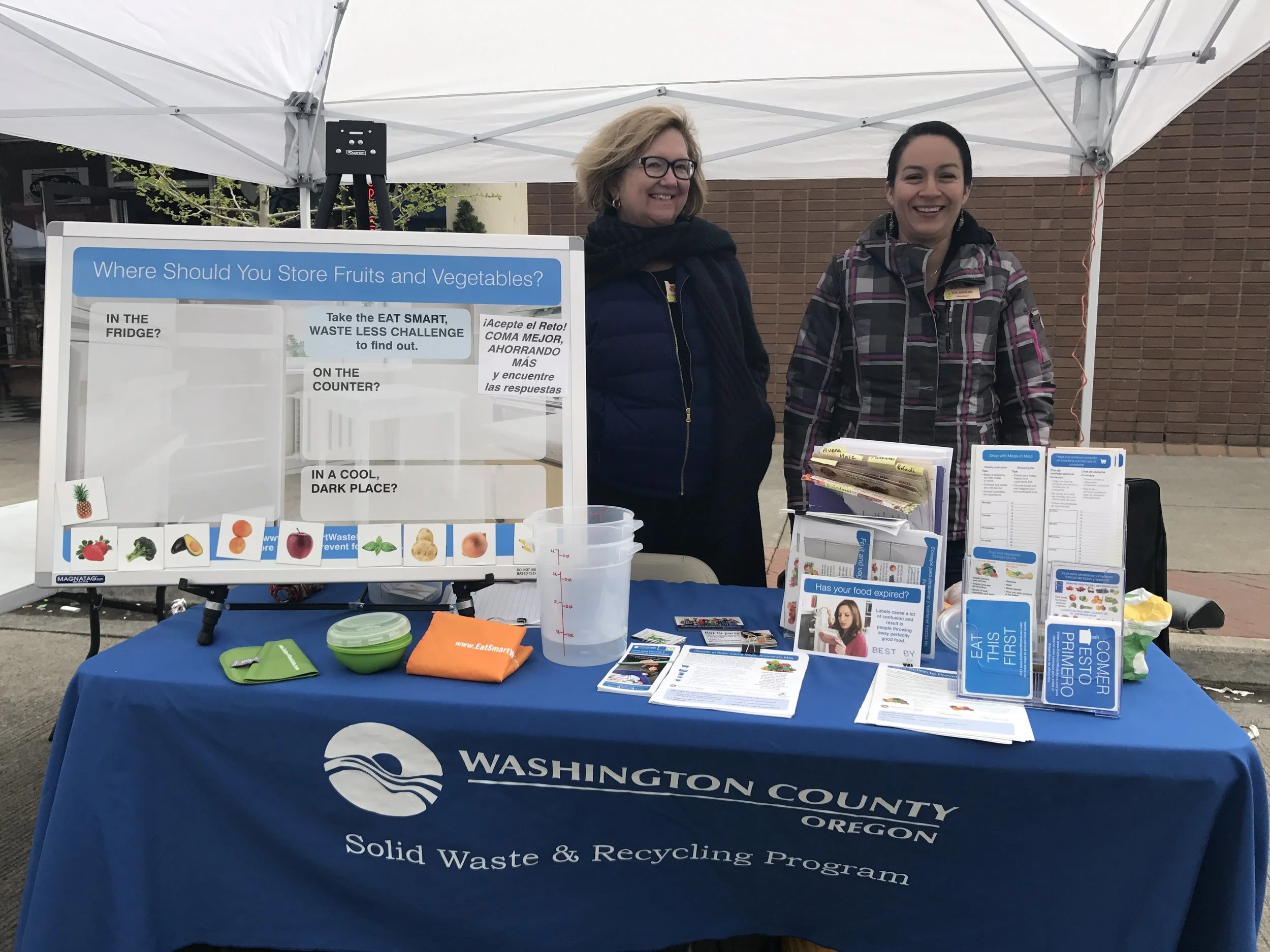 Andrea and classmate Eva engage Latino Festival attendees with ideas to reduce food waste.