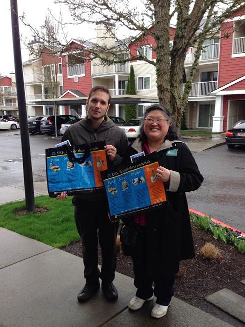 Nick and Francis demonstrate bags for residents to collect materials and carry them to centralized recycling.