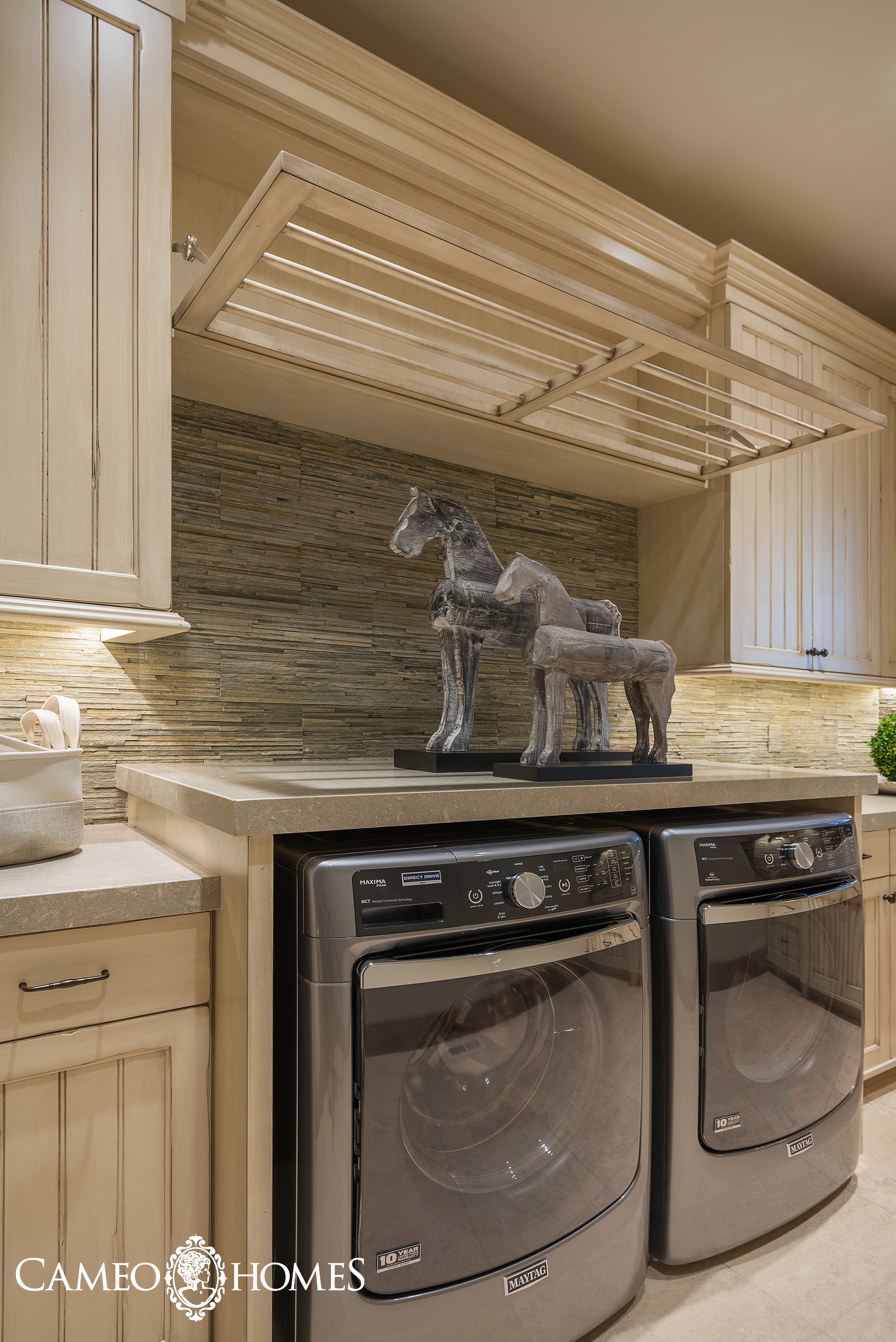 Notice the pull down drying rack above the washer and dryer provides more space for drying clothes. PC: Lucy Call
