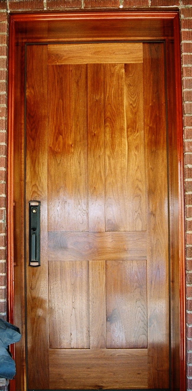 Exterior 1 3/4" unit in walnut. Walnut jamb 12" deep. Brickmould, in redwood, custom made to match the existing profile.
