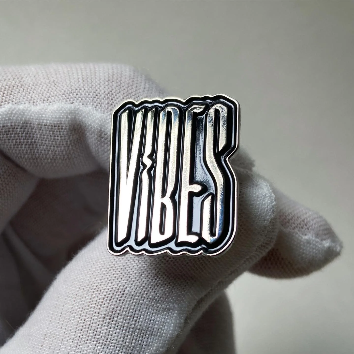 Enamel pins featuring independent type designers
