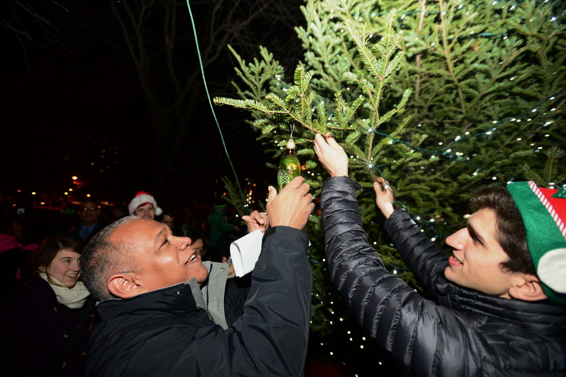 NYC Parks Commissioner Mitchell J. Silver hanging an ornament with FGPC Programming an Development Coordinator Julian Macrone