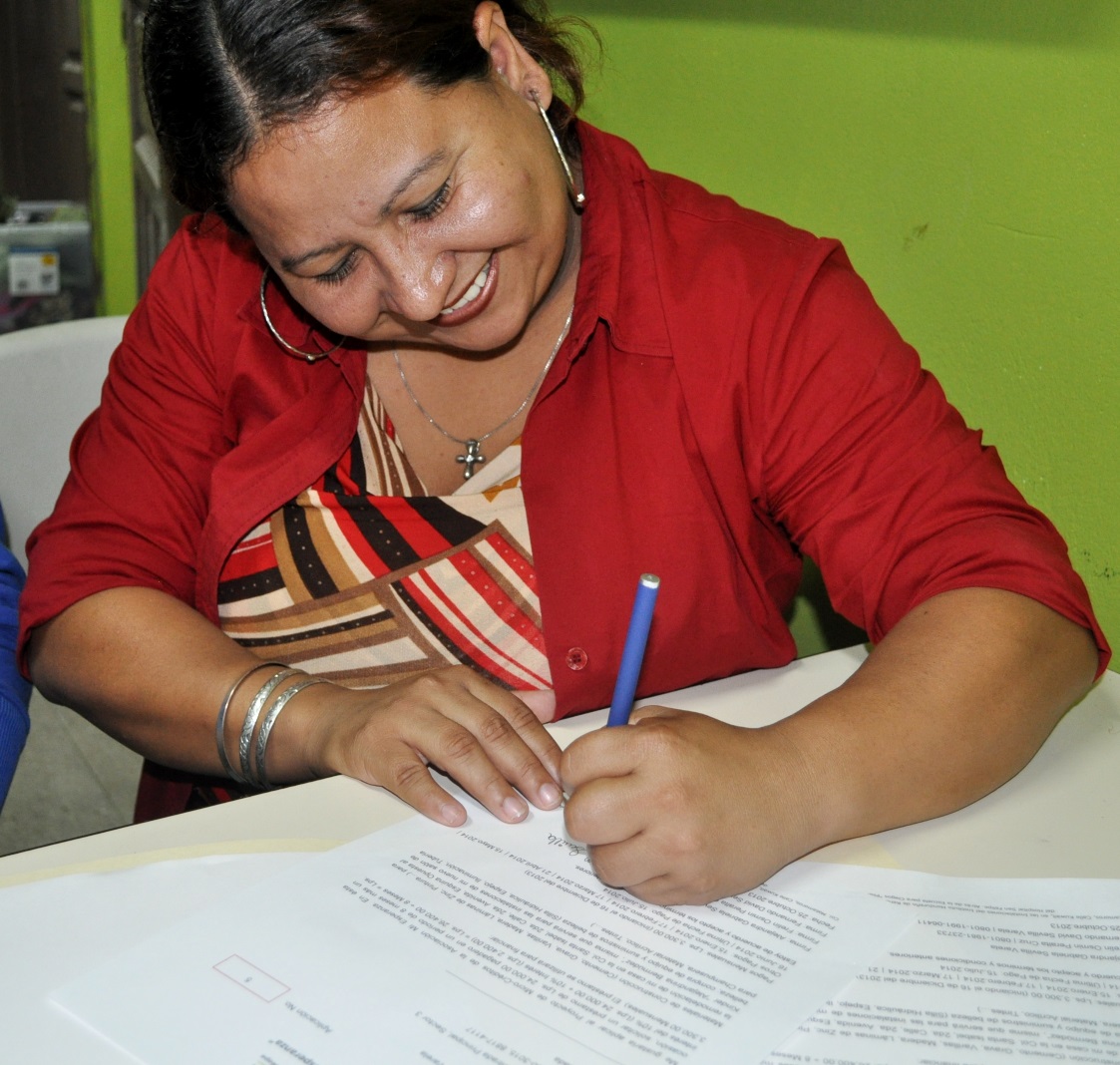  signing her first micro-loan papers 2013 