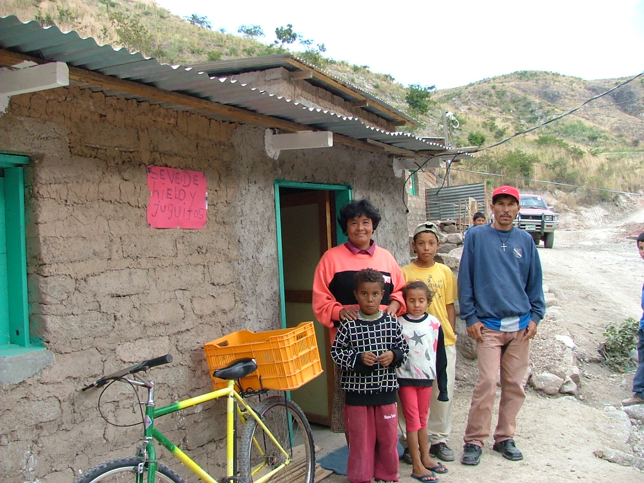  Hilda with her family in front of her house 
