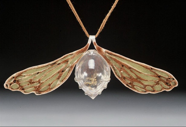 Wasp Pendant: 2004 In 2004 I was busy working away on my senior thesis, and I'd learned a wonderful distraction from all that stress: enameling. I was continuing my research on insects, creating jewelry pieces about the greater meaning of these little guys. I was currently dwelling on bees and wasps. How alone, they seem so small and weak, yet in swarms, they seem strong & invincible. I was digesting a lot of news about our troops in the Iraq at the time, was thinking a lot about how the noble little honey bee could easily compared to a single soldier. This piece is influenced by the designs of René Lalique created with plique-a-jour enamel (which is enamel (powdered glass) suspended in empty spaces of silver or gold.) The results are similar to stained-glass, but far more painstaking and time consuming. Contained under the hand-formed acrylic dome is a single wasp. 