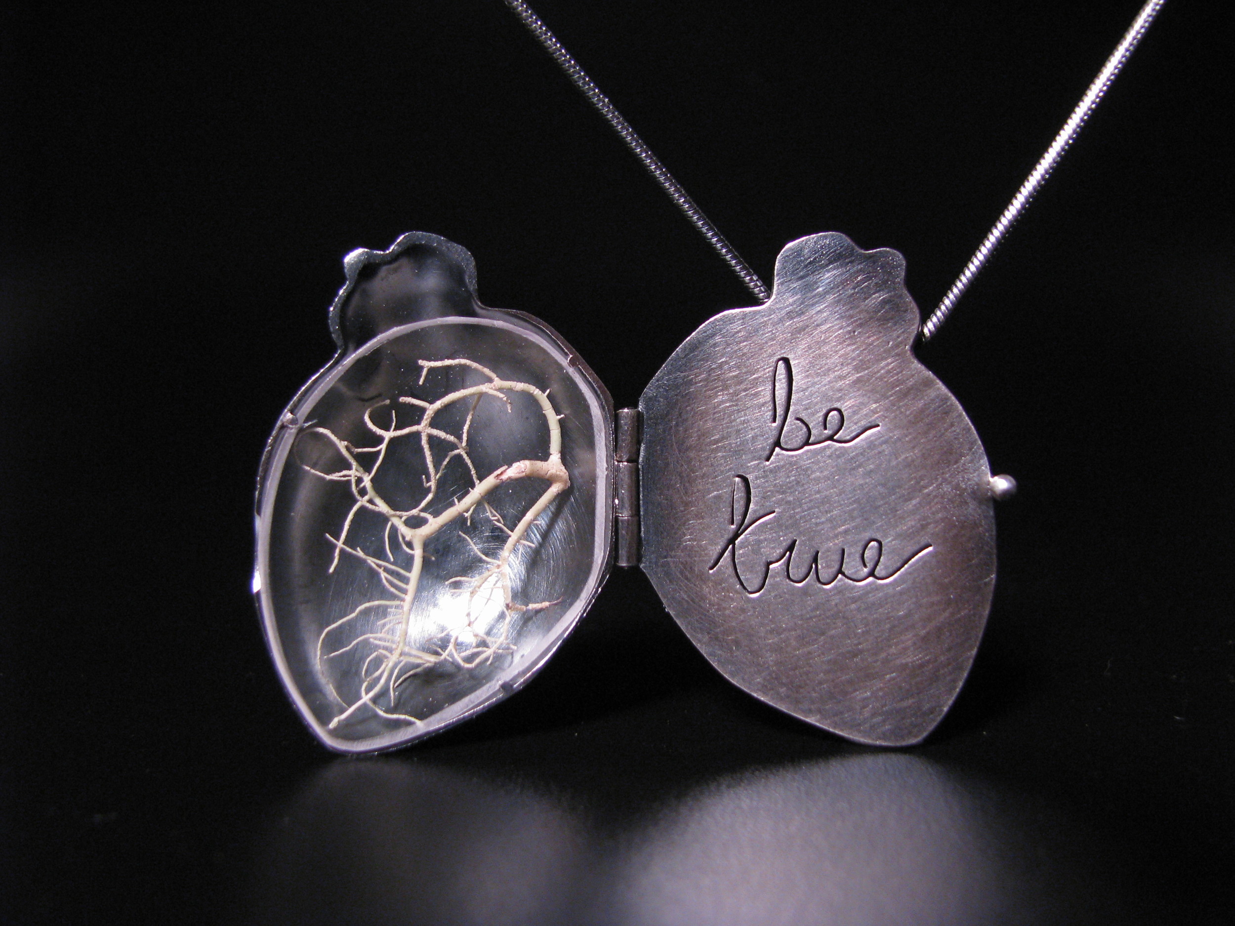"Listen" 2007 This one was pretty special. I'd always wanted to make lockets, since working on the hinged heart piece from 2002. Thier storytelling capabilities, sentimentality, and ergonomics seemed to draw me in. I created my first locket- and anatomical heart with red birch branches which stated 'listen'. Taking an opportunity to show it at an art show, I slapped a high price tag on it, with the rationale of "I don't want to sell it, this will be too expensive". While at the show, and old friend and art collector chatted to me about the meaning of the piece, where the ideas came from, and the emotion behind the piece. Half way through the conversation, he said "I'll take it" (which is why I don't have a photo of the actual piece, this is a similar one which I made next). The story of the locket only starts there- he bought it as a last gift for his wife who was terminally ill with cancer, which touched me so, it almost brings me to tears. My journey of making jewelry with a true emotional connection had just begun... 
