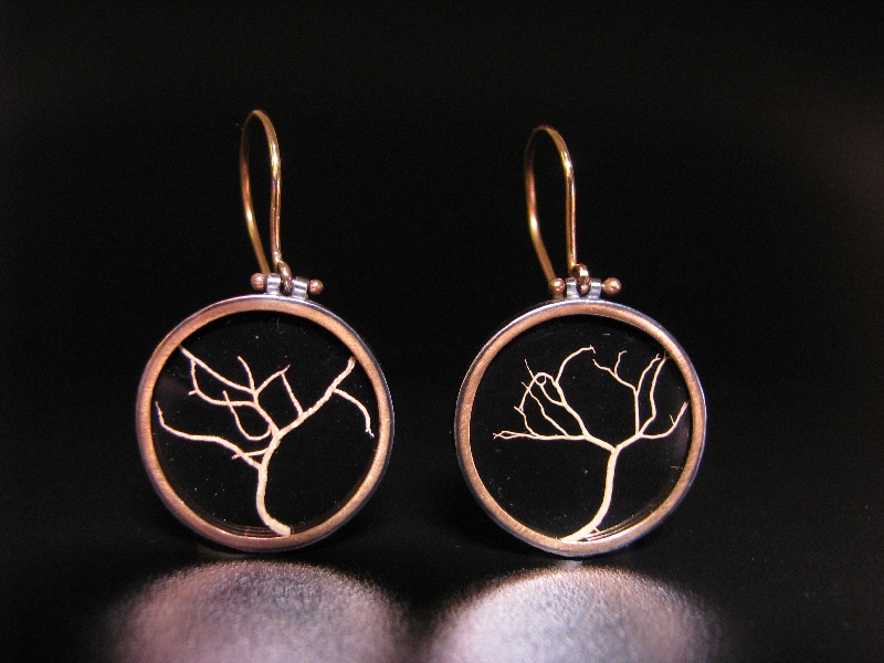 Lichen Memento Earrings: 2009 For the first time in 5 years, I'd put enough a large enough body of work to show. I was working with Vessel and Lonnie was pushing me to make wonderful pieces. I'd made an entire new body of work- very sentimental created with rose petals, anatomical hearts, and Victorian-era themes. We put together a show which around Valentine's Day and the response was astonishing: we couldn't keep pieces on the shelf very long, I was constantly scrambling to replace what had sold. It felt... wonderful. It was my first full collection since art school, and I was being urged to make very strong work by an extremely supportive gallery owner (looking back, that was an essential component). These earrings felt very complete to me: I was directly inspired by a pair of Victorian Memento Mori earrings I had seen, yet I re-arranged the sentiment to honor nature instead of a person. I began developing my ideas of WHY we wear jewelry, and our emotional drive behind those reasons. 