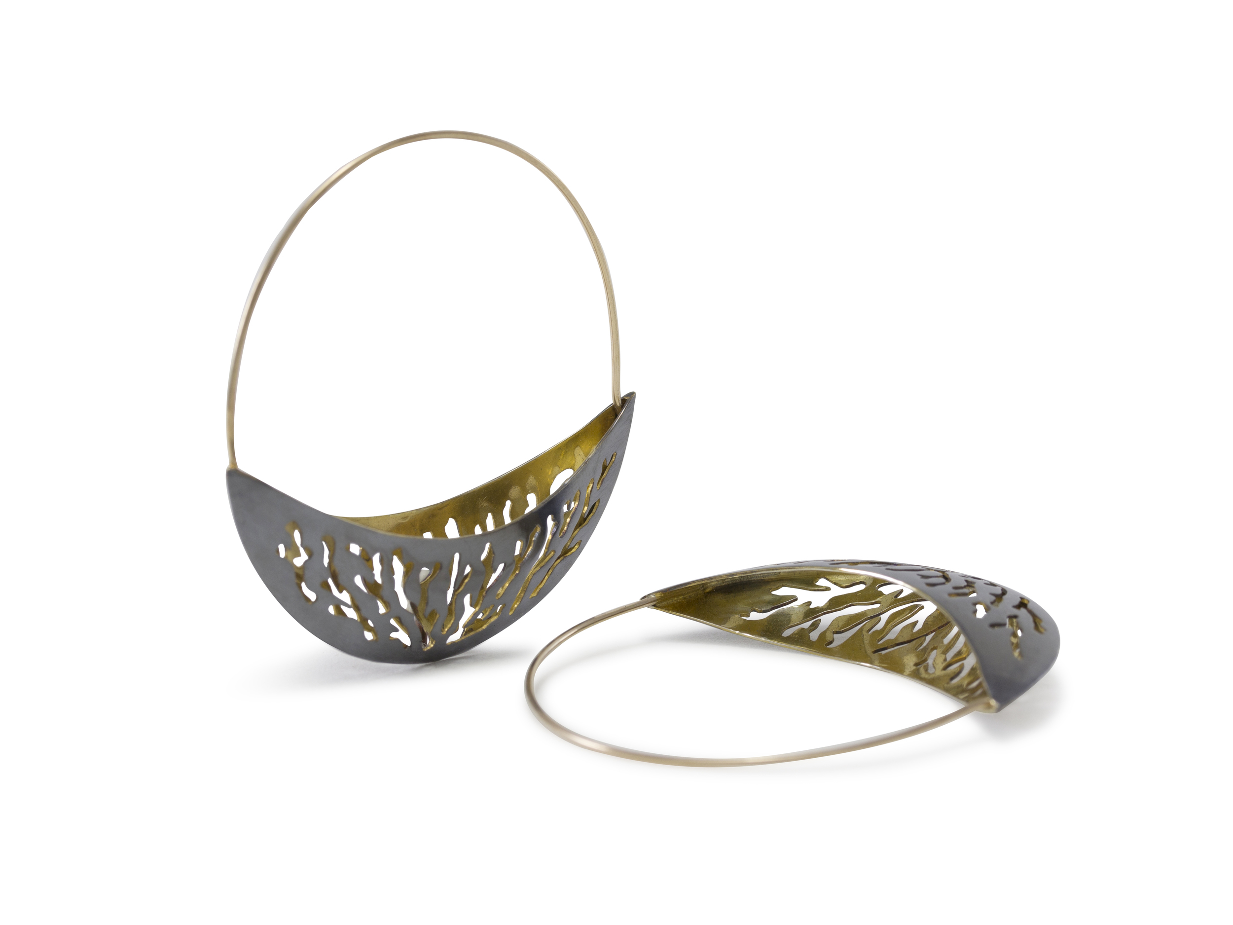 Puffed Crescent Hoops: 2015 Coming full circle, I revisited a few themes with these earrings and brought so much more to the table. Four layers of hand-sawed coral-themed patterns, domed into perfect crescents to create light, wearable statement earrings in oxidized sterling silver exterior, with glowing 18k interiors. I see these as my current direction in my mind's eye: creating glowing work with depth, dimension, and high wearability. In my years of making jewelry, I worked hard to make my jewelry highly wearable and easily functionable. Often the first reaction when I hand someone a pair of earrings is: 'oh, they are so light!: My lessons are sometimes subtle to the eye- working with thinner materials with a delication hand, to create feather-light graceful pieces. These are true pieces of art, and their platform is the body. This pair of earrings sold shortly after I finished them. 