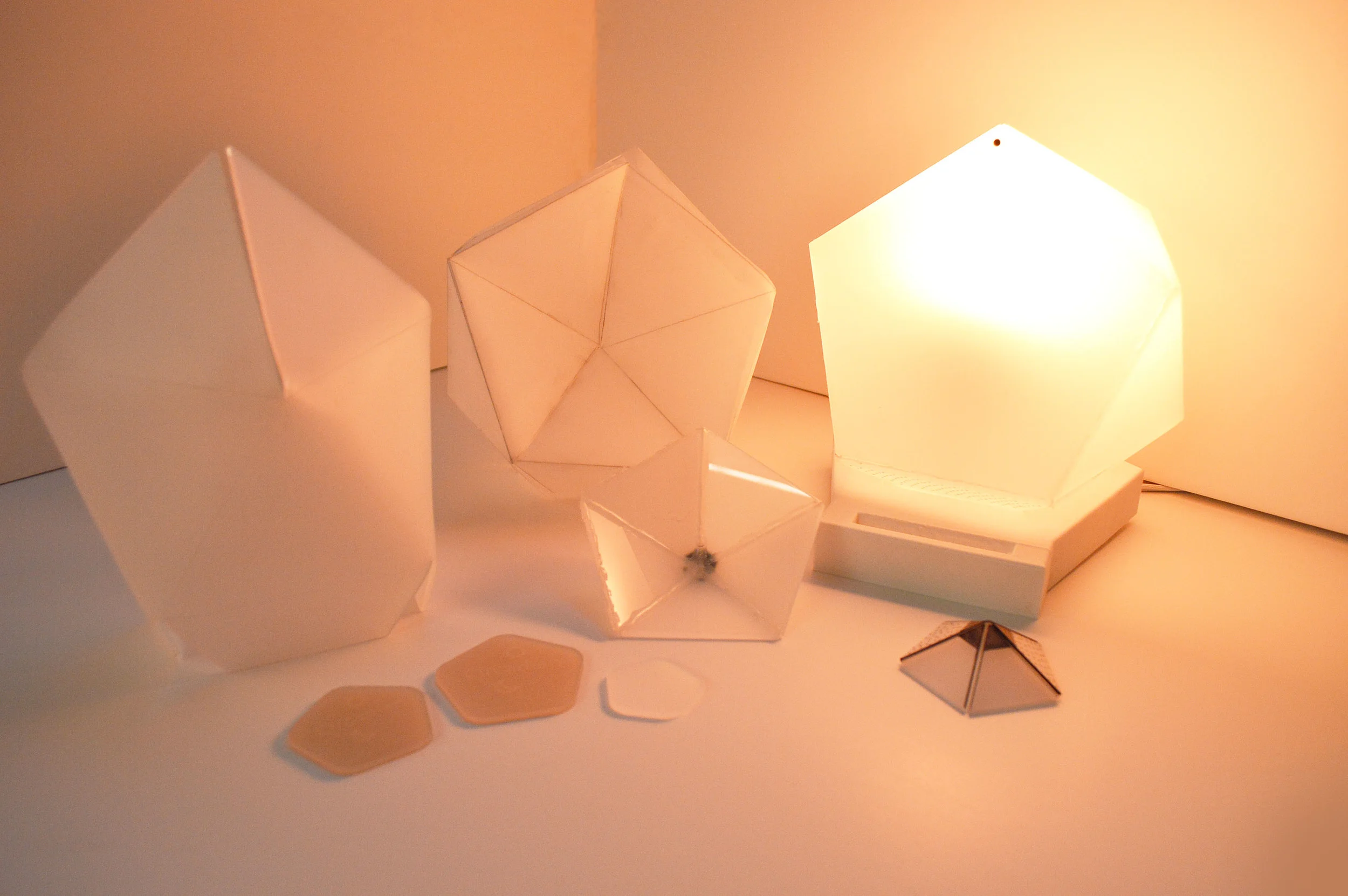 EARLY PROTOTYPES: I used paper and velum in early prototypes, then experimented with acrylic and 3D printed objects to create more high fidelity versions.