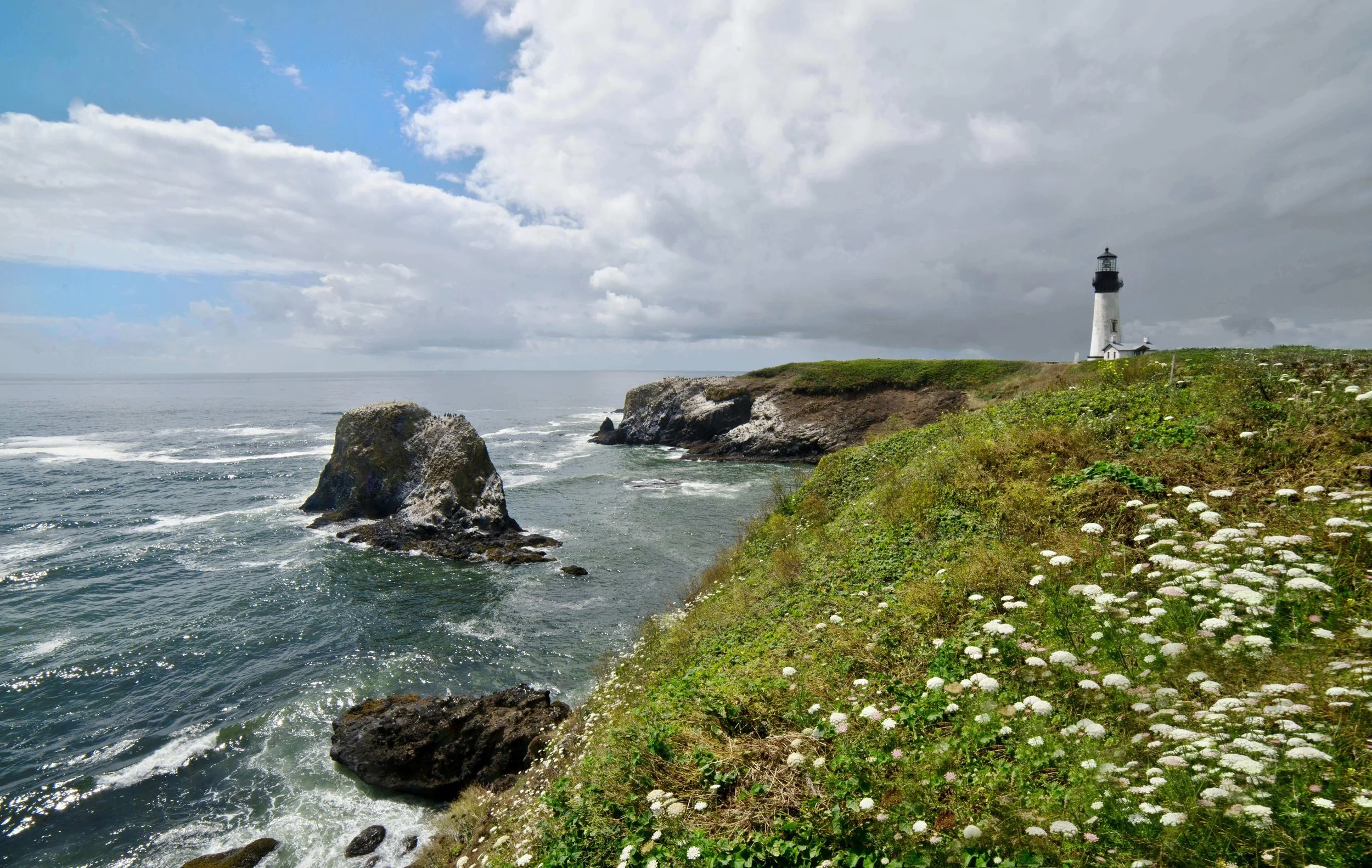 Spring season at the Kittery Maine coastline with lighthouse, ocean waves, and blooming flowers