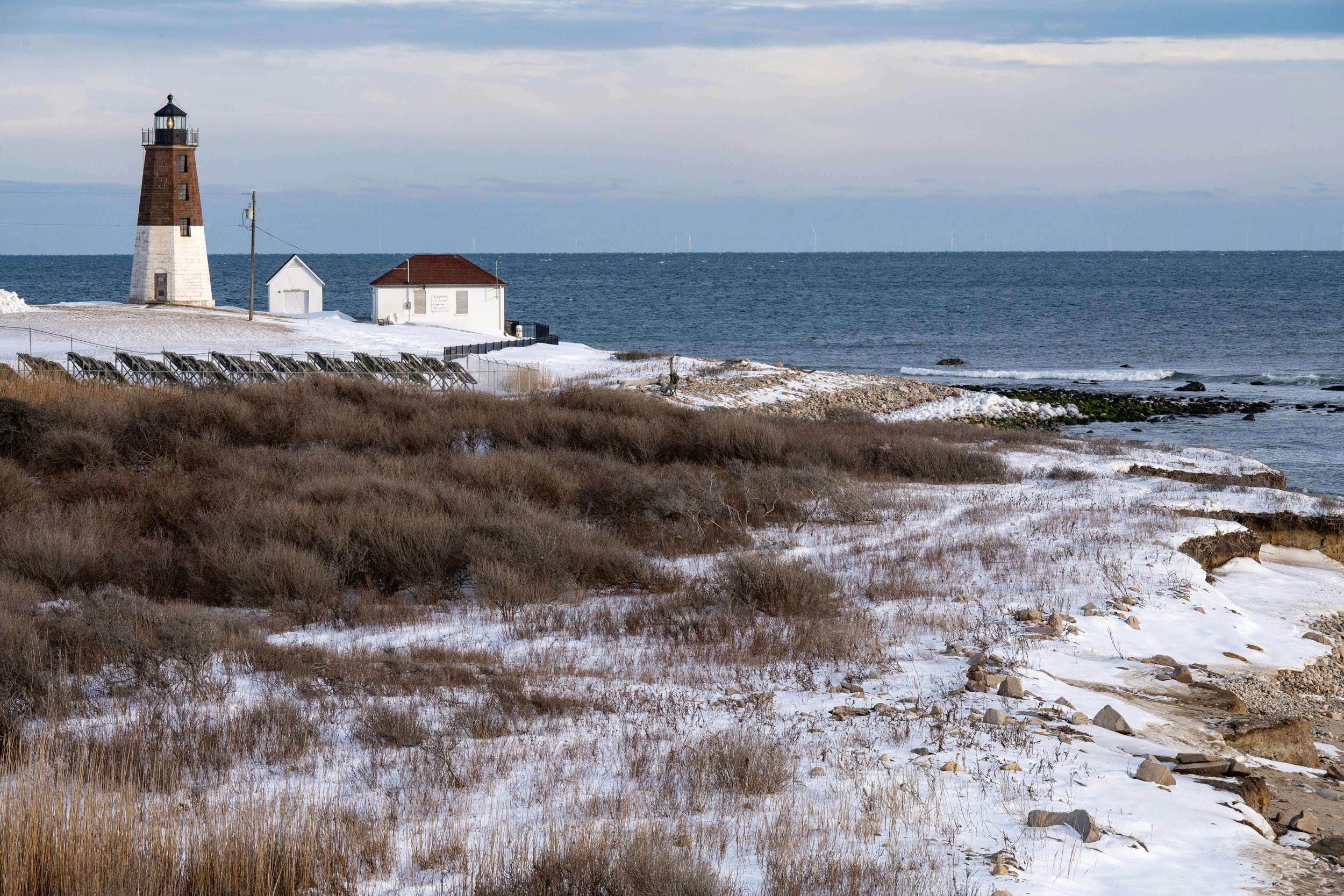 Snow-covered coastal lighthouse during winter in Kittery Maine