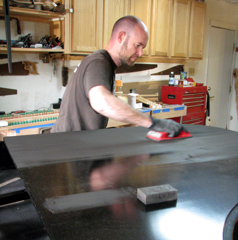 Rubbing out the lid. Steinway & Sons Model L. Hand-rubbed black lacquer, satin finish. Watson Piano Works, 2015.