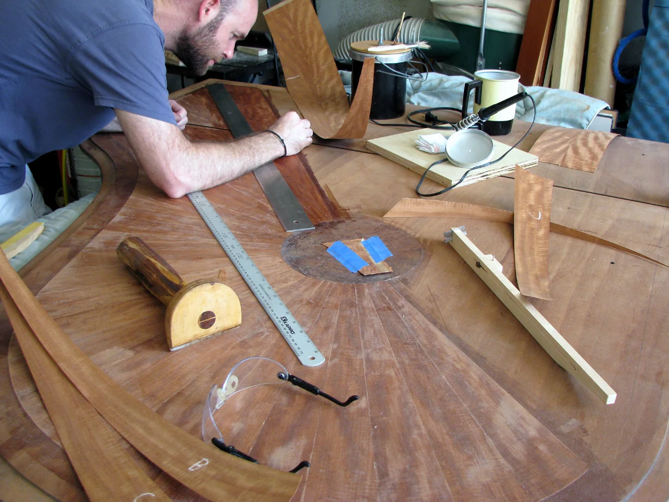 Measuring and applying veneer to lid. Steinway & Sons "Sunburst" veneer project. Veneer design and execution by Watson Piano Works, 2015.