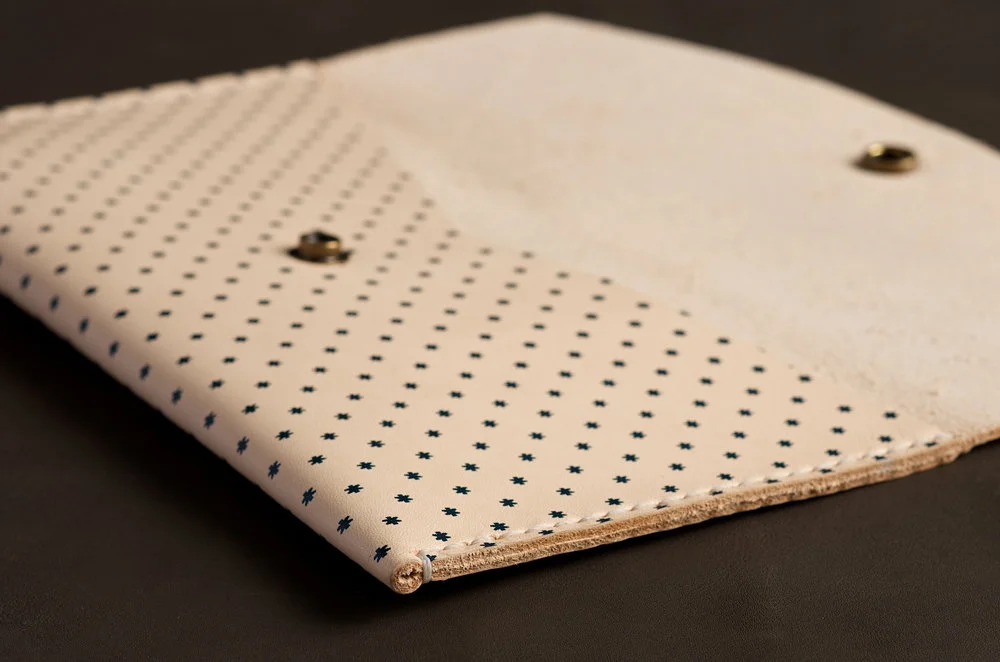 patterned hand stitched leather clutch