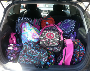 A trunk filled with backpacks from Operation Backpack 2013.