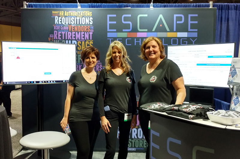 Arin, JenE and Terri show off the new booth