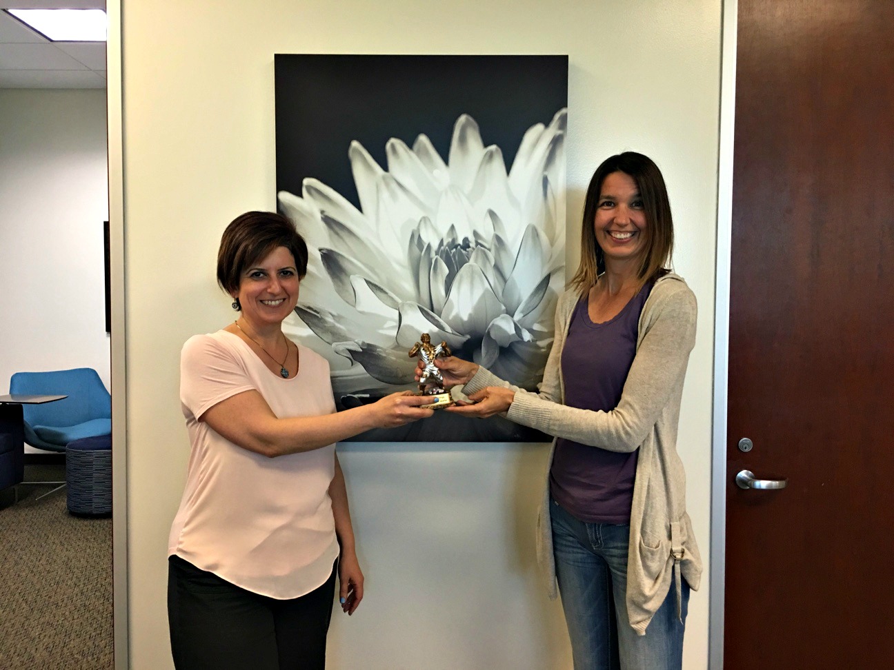 Arin Simonyan, HR/Payroll Software Support Lead and recipient of the Escape Employee of the Second Quarter award, passing the baton to Robin Fiske, Technical Support Analyst and recipient of the Escape Employee of the Third Quarter award.