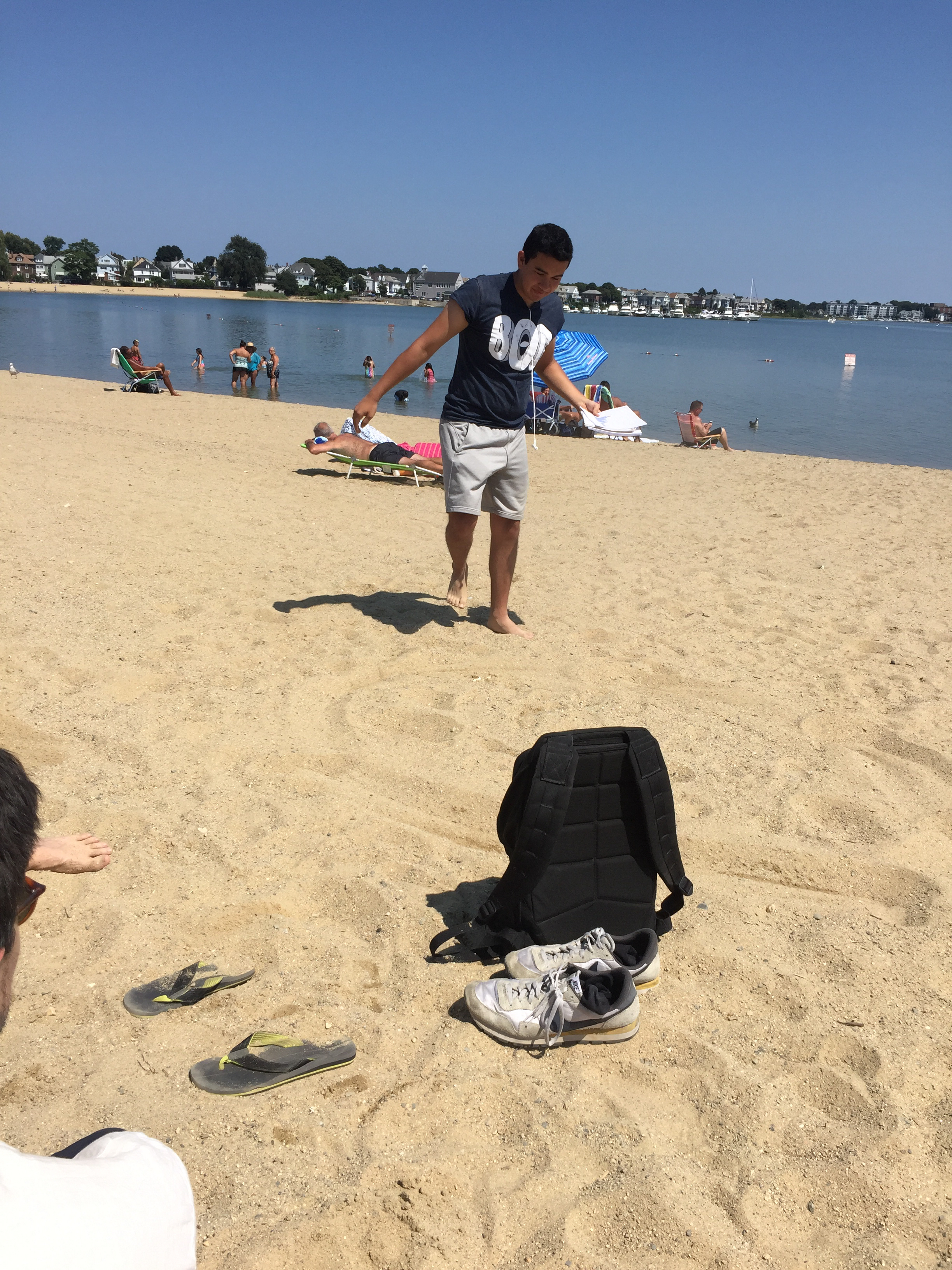 Julian drawing figures in the sand.