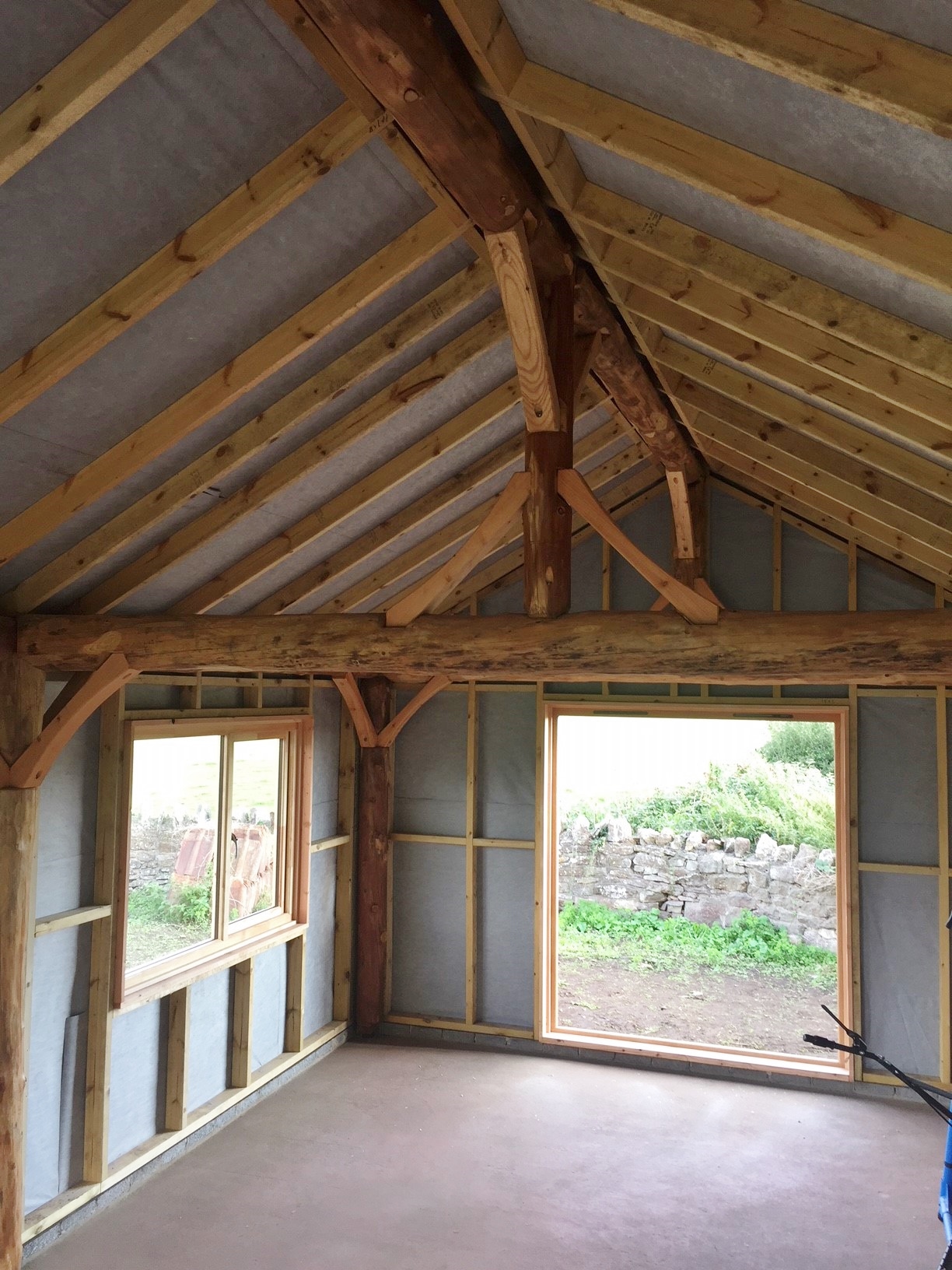 Interior round pole larch timber frame rafters garden building roundwood design bristol self build.jpg