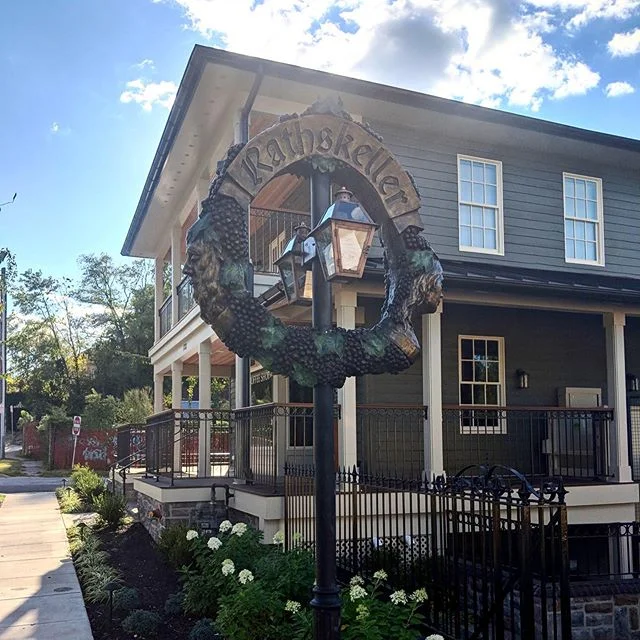 A bunch of years ago I sculpted this sign for @rathskellermd. At the time of sculpting it, it kinda looked like an awkward ring, but @johnoc69 had a vision. Here it is in its complete envisioned glory. The Rathskeller is officially open with it’s sister business @screaminagnes coffee shop upstairs. If you’re in Elkridge, MD it’s a must visit! I am so happy to have been a part of this business and see this awesome work come to life.
The ring is designed based off of a family “church key” design picturing Father Rhine and Daughter Mosel. The Rathskeller is a German inspired wine bar. There is some more collaborative works by @johnoc69 and I of fun drinking German skeletons, stop by to check them out!