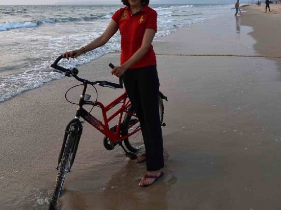 me cycling on the beach in a Ralph Lauren Polo tee and Ralph Lauren tracks and LLBean flip-flops. Park Hyatt Hotel, Goa, image©sourcingstyle.com.