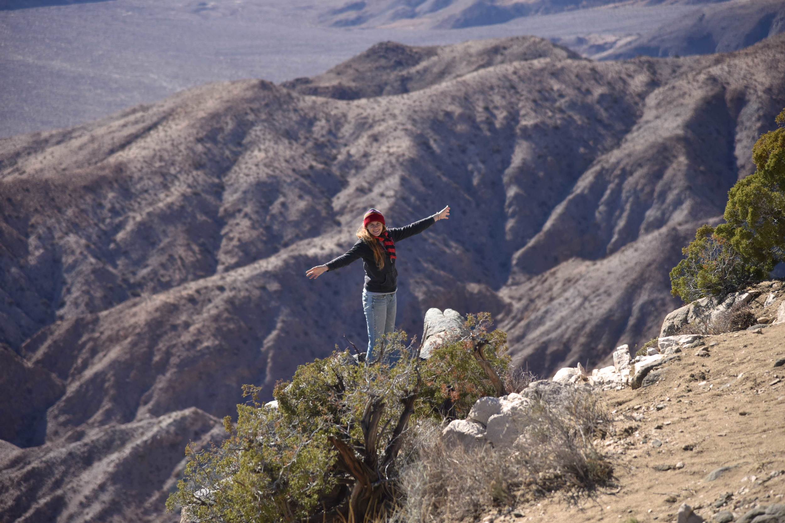 Keys View , Joshua Tree National Park. My friend Katie standing on the edge of a rock-very dangerous unless you are a trained mountain climber (like my friend) or the winds might just blow you away! Image©sourcingstyle.com