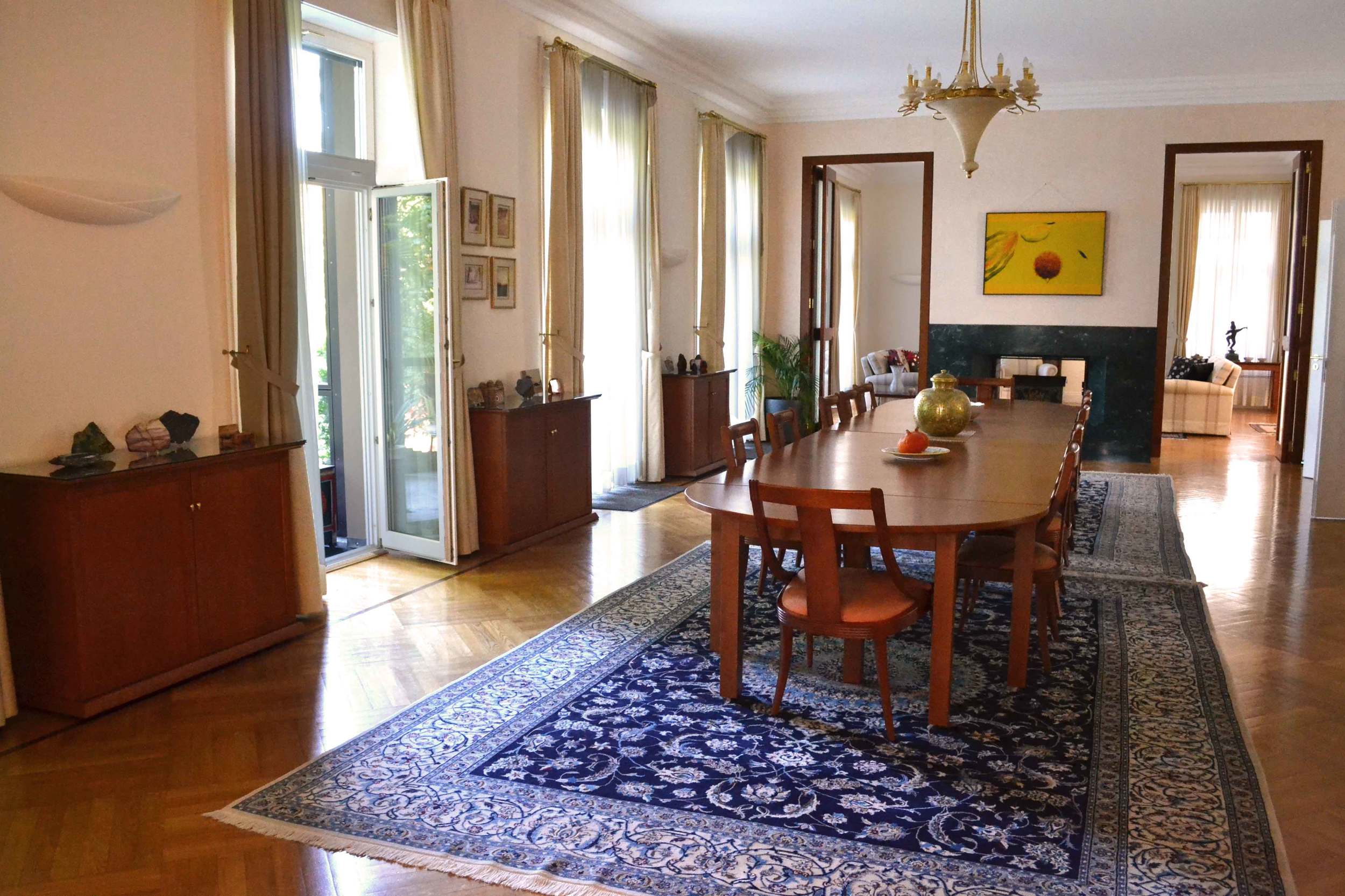 The formal dining room with glass doors opens on the lawn. Image©gunjanvirk
