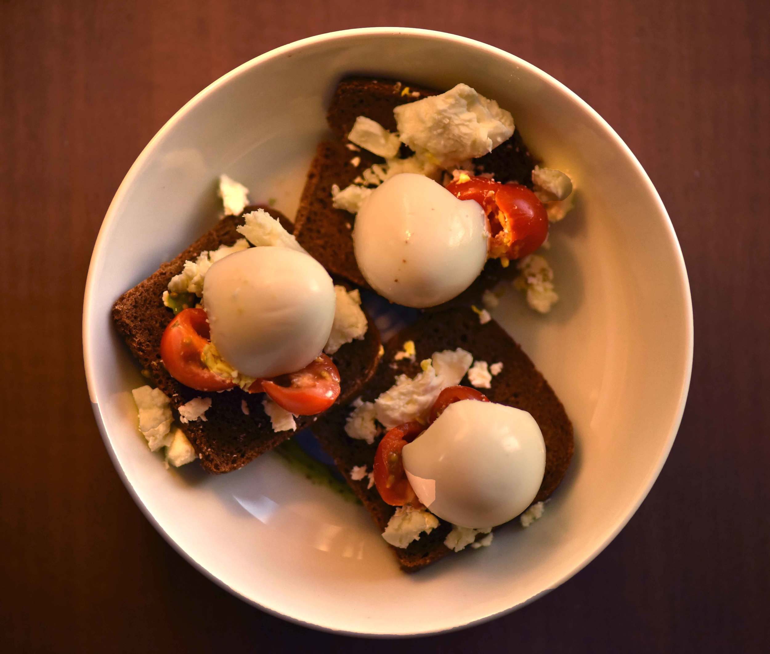 Organic bread with cherry tomatoes, cheese and eggs. Image©gunjanvirk