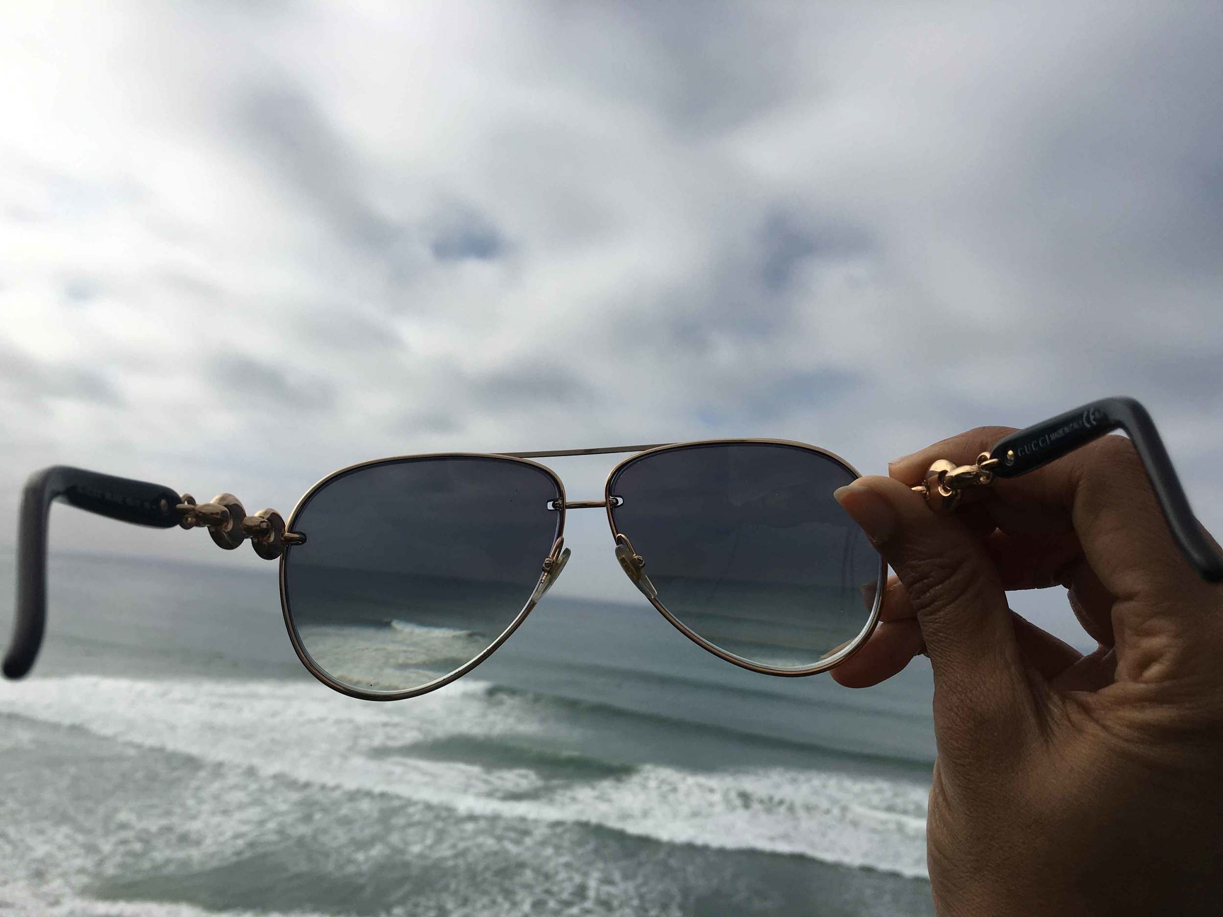 Seeing the world through my Gucci shades, ocean view, stormy day at the ocean, Swamis beach, Encinitas, California. Image©sourcingstyle.com