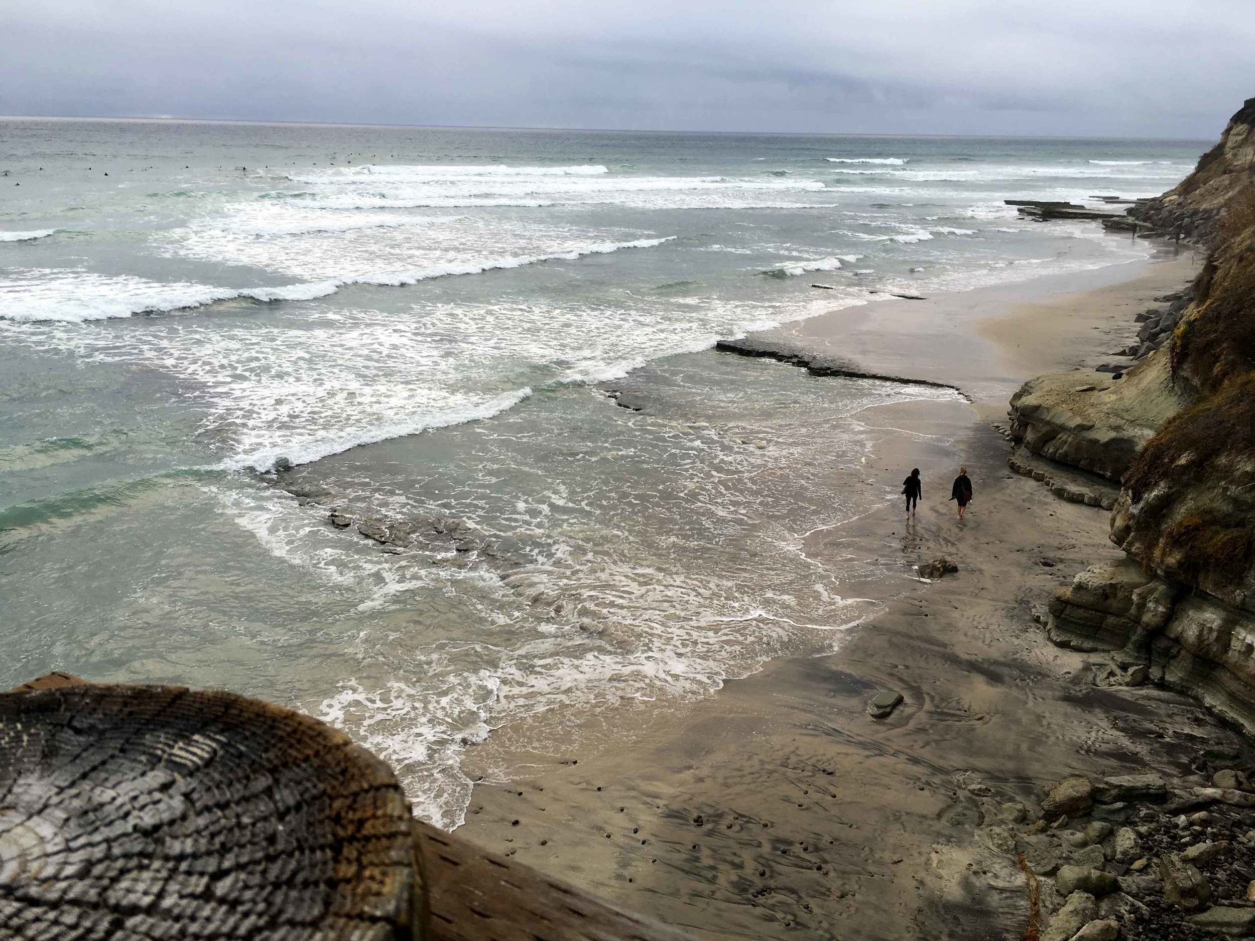 Surfers, stormy day at the ocean, ocean view, Swamis beach, Encinitas, California. Image©sourcingstyle.com