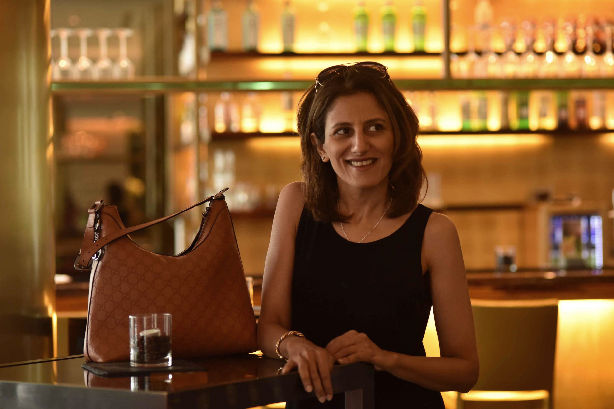 Wearing Eileen Fisher black tank dress in viscose jersey, little black dress, Gucci handbag, Radisson hotel, Düsseldorf city, Germany. Image©sourcingstyle.com, Photo: Nicola Nolting.
