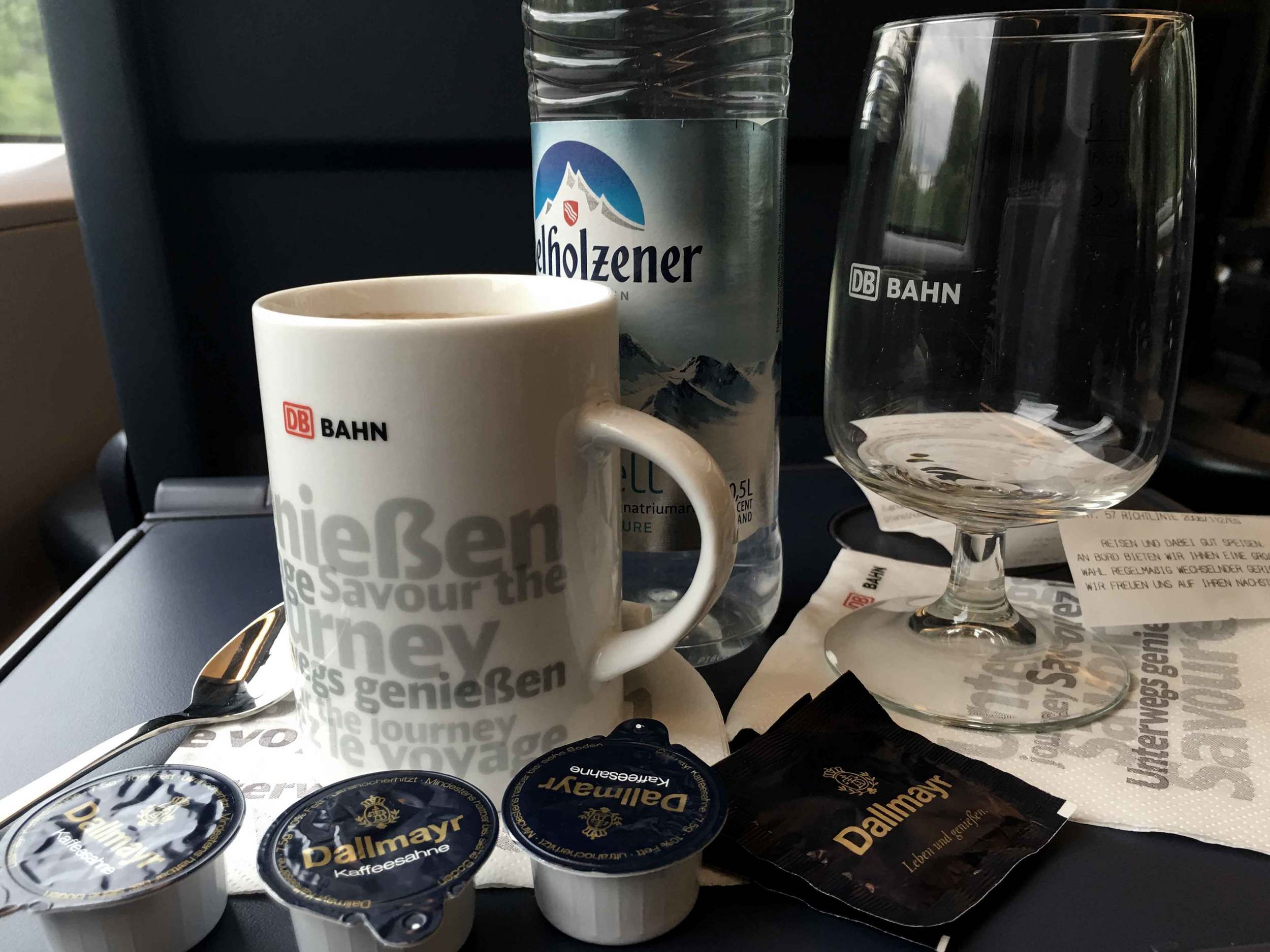 Coffee with milk and still water, Kaffee mit Milch und stilles Wasser, Deutsche Bahn ICE train, Inter City Express, first class compartment, train travel in Germany. Image©sourcingstyle.com
