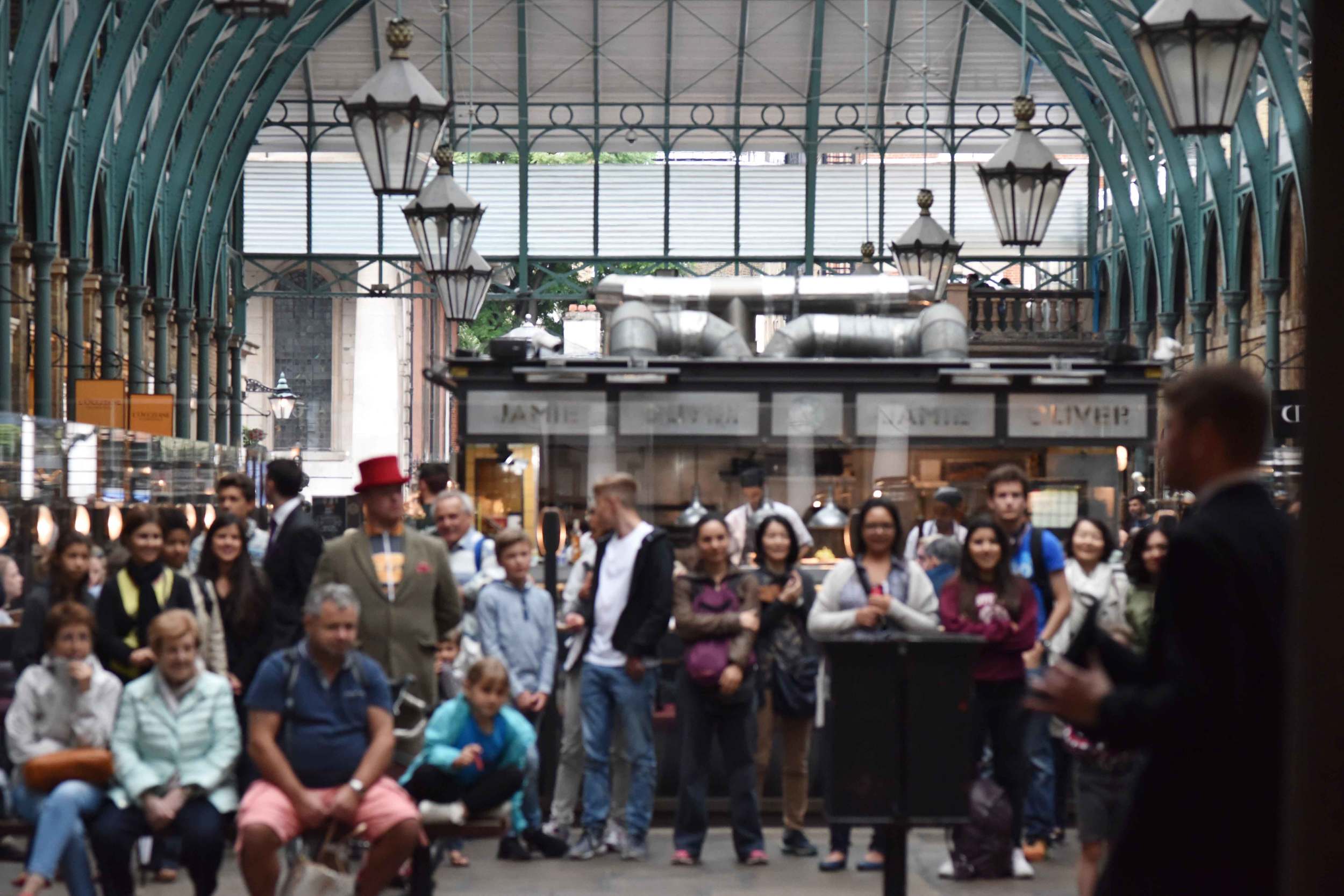 Crowd watching an artist perform at Apple Market, Covent Garden, London, UK. Image©sourcingstyle.com