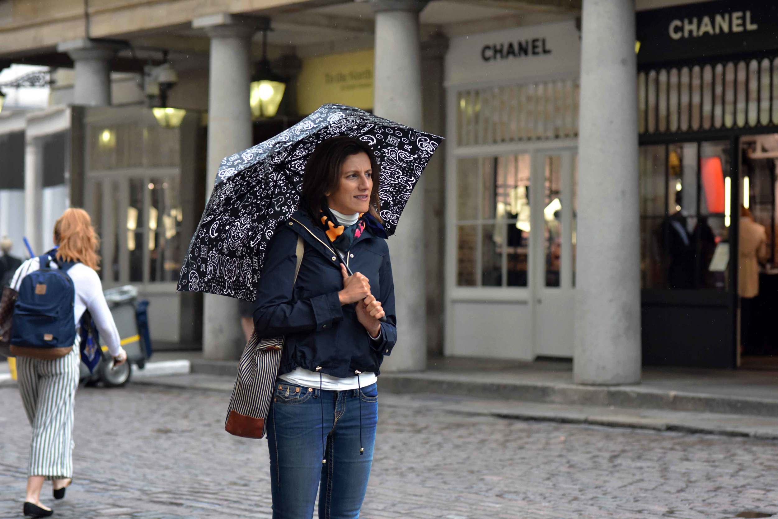 Zara water repellent jacket, Ralph Lauren polo sweater, Zara printed pocket square, Zara bandana print umbrella, True Religion jeans, Covent Garden, London, UK. Image©sourcingstyle.com