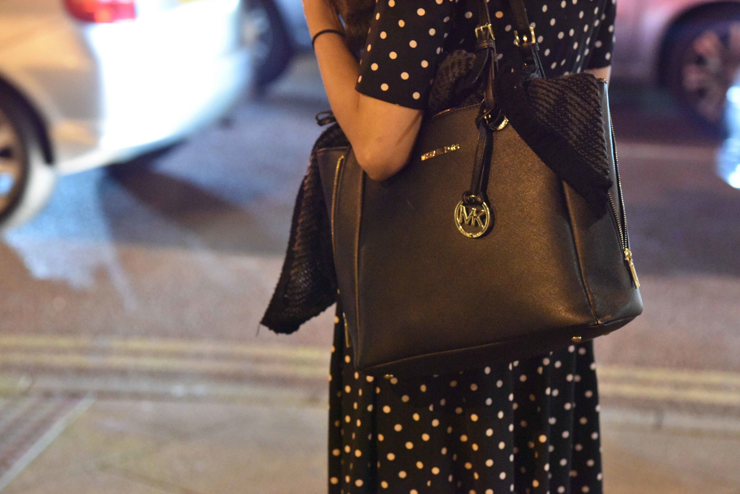 Michael Kors saffiano leather black tote, clicked at Wembley Park underground station, London, U.K. Image©sourcingstyle.com
