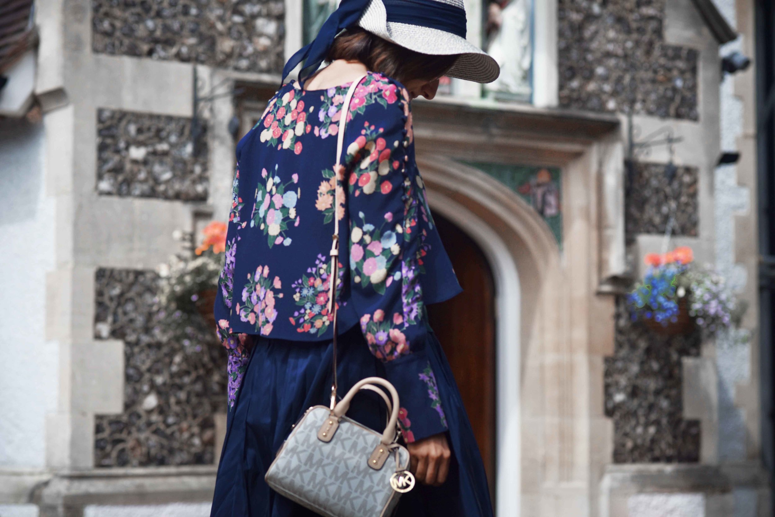 Zara floral top, Talbots silk Taffeta skirt, Talbots silk camisole, Michael Kors bag, M&S hat. Image©sourcingstyle.com