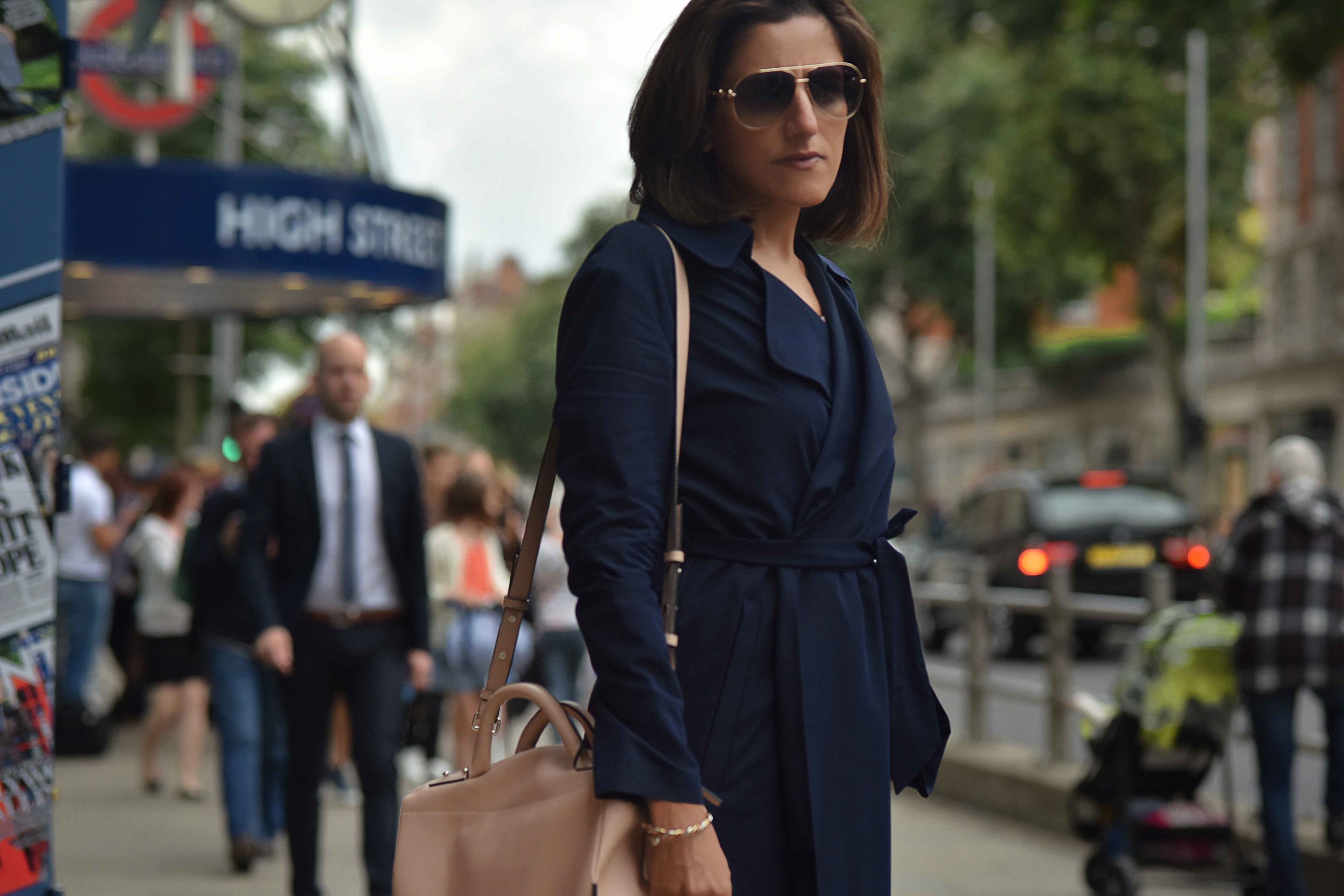 Marks & Spencer trench coat, Karen Millen bag, Gucci sunglasses, High Street Kensington, London. Image©sourcingstyle.com