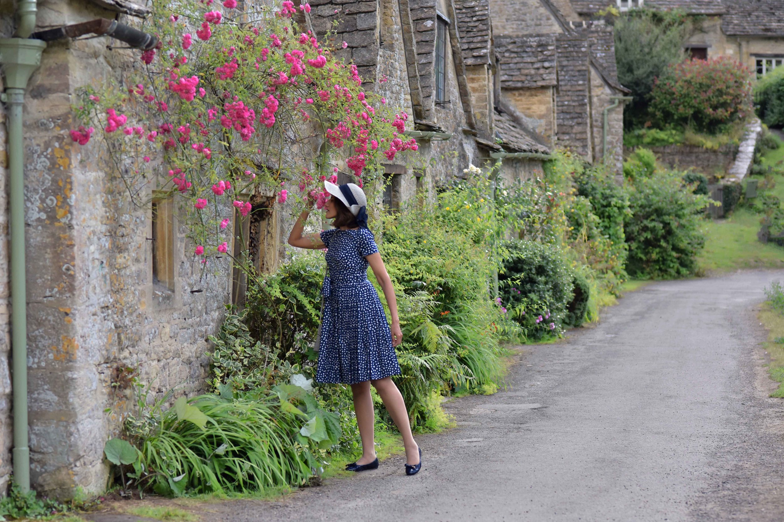 Prada dress, Prada ballet flats, Cotswold stone cottages, Arlington Row, Bibury, Cotswold, England. Image©sourcingstyle.com