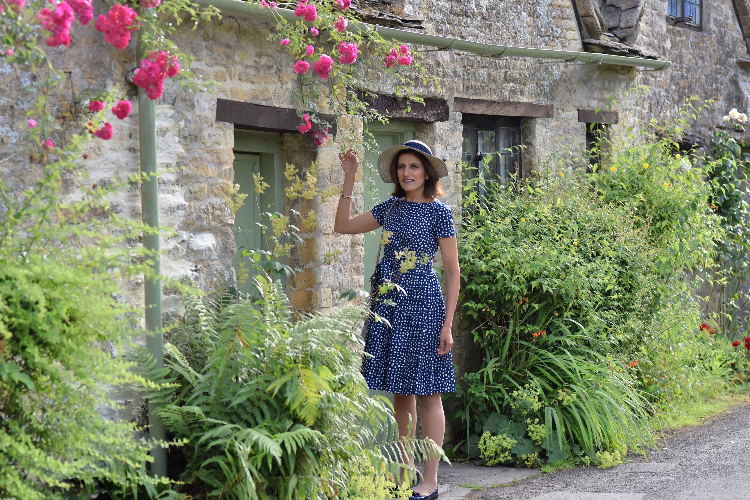 Prada dress, Prada ballet flats, Cotswold stone cottages, Arlington Row, Bibury, Cotswold, England. Image©sourcingstyle.com